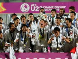 Japans players celebrate with the trophy following the AFC U23 Championship final football match between Japan and South Korea at Abdullah Bin Khalifa Stadium in Doha on January 30, 2016