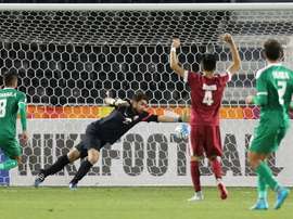 Qatars goalkeeper Muhannad Naim (C) tries to save a shot during their AFC U23 Championship 3rd place football match between Qatar and Iraq in Doha on January 29, 2016