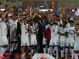 Chennaiyin FC players pose with the trophy as they celebrate after winning the final match against FC Goa during the Indian Super League football tournament on December 20, 2015