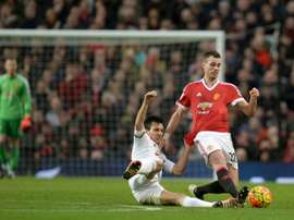 Manchester Uniteds midfielder Morgan Schneiderlin (R) is tackled by Swansea Citys midfielder Jack Cork during the English Premier League football match January 2, 2016