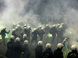Riot police clashes with fans during a football match between Athens arch-rivals Olympiakos and Panathinaikos on February 22, 2015