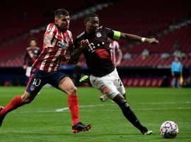 Alaba (R) wants to play in midfield at his new club. AFP