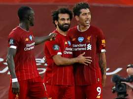 Salah (C) is Liverpool's best paid player. AFP