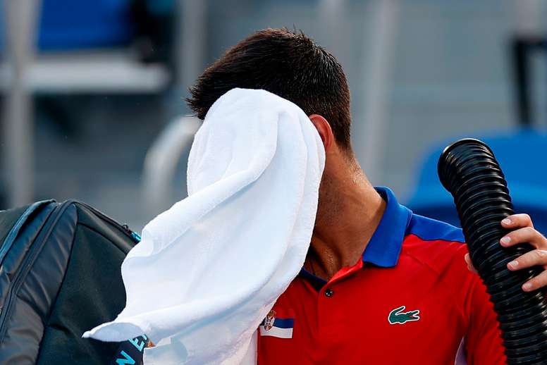 El serbio Novak Djokovic se refresca debido a las altas temperaturas. EFE/Juan Ignacio Roncoroni